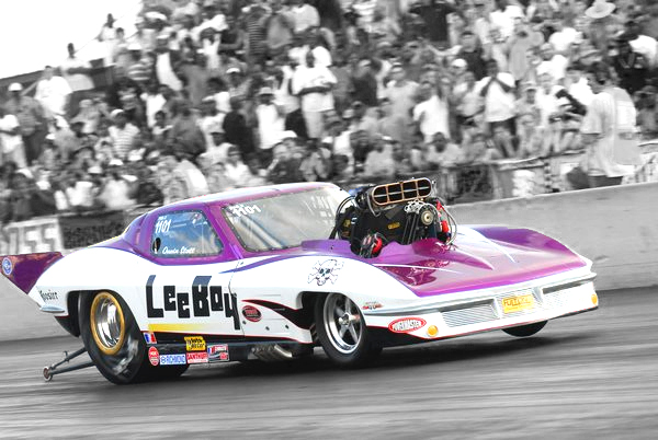 Race car speeds down racing strip